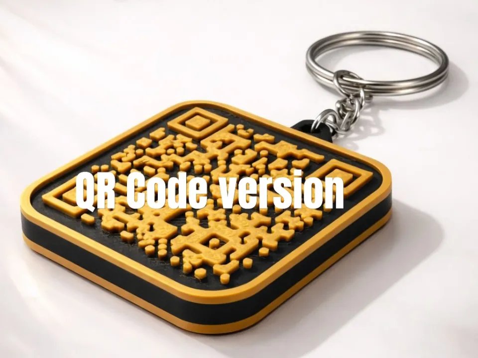 Orange and charcoal 3D-printed keychain with an embossed QR code on a steel key ring